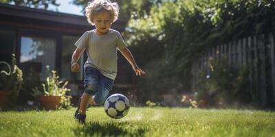 child boy playing football in the backyard photo