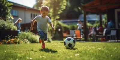 child boy playing football in the backyard photo