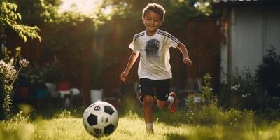 child boy playing football in the backyard photo