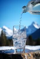 clean drinking water in a bottle against the background of a lake and mountains photo