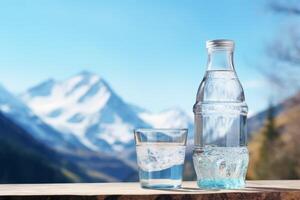 clean drinking water in a bottle against the background of a lake and mountains photo