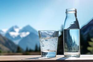 clean drinking water in a bottle against the background of a lake and mountains photo