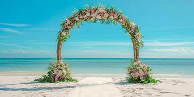 decorative wedding arch on the white sand seashore photo