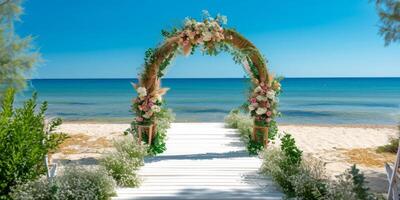 decorative wedding arch on the white sand seashore photo