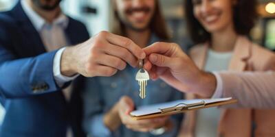 realtor hands over the keys to the apartment to new residents photo