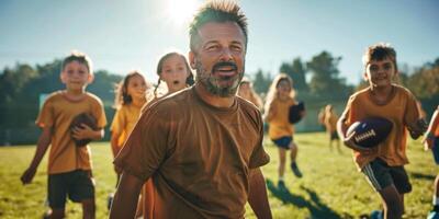 coach trains children in American football photo