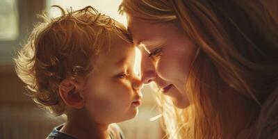 young mother touches nose with her little child photo