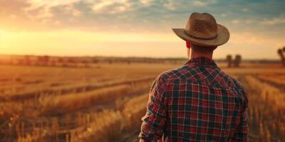 Farmer male in a straw hat against the background of a field photo