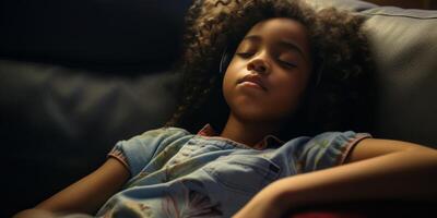 African American child girl falls asleep on the sofa photo