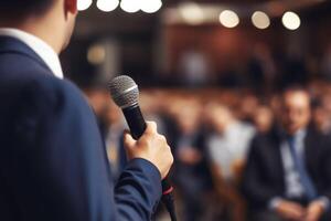 man with microphone at public speaking photo