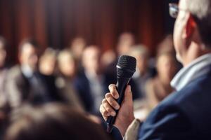 man with microphone at public speaking photo
