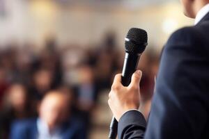 man with microphone at public speaking photo