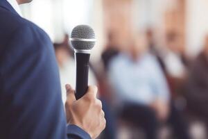 man with microphone at public speaking photo