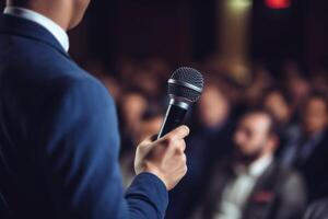 man with microphone at public speaking photo