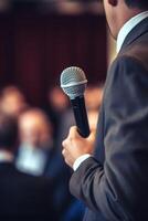 man with microphone at public speaking photo