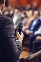 man with microphone at public speaking photo