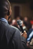 man with microphone at public speaking photo