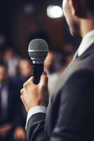 man with microphone at public speaking photo