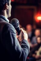 man with microphone at public speaking photo