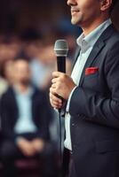 man with microphone at public speaking photo