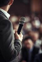 man with microphone at public speaking photo