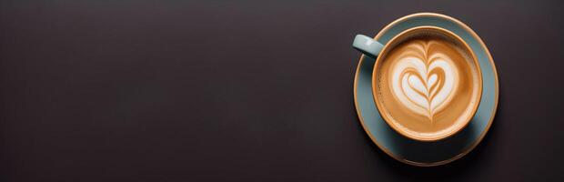 A cup of coffee with heart on a panoramic dark background photo