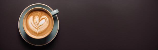 A cup of coffee with heart on a panoramic dark background photo