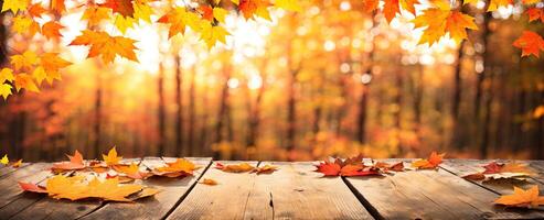 wooden table with autumn leaves around the edges on a defocused autumn background banner photo