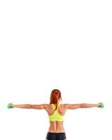 athletic girl in sports underwear with dumbbells in her hands on a white background, rear view banner photo