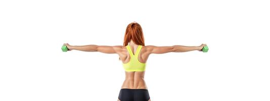 athletic girl in sports underwear with dumbbells in her hands on a white background, rear view banner photo