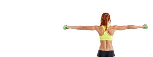 athletic girl in sports underwear with dumbbells in her hands on a white background, rear view banner photo