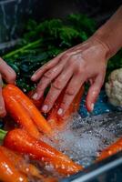 hands wash vegetables splashing water photo