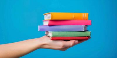 hands holding stacks of books photo