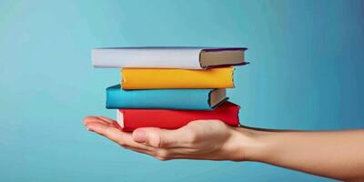 hands holding stacks of books photo