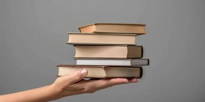 hands holding stacks of books photo