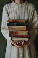 hands holding stacks of books photo