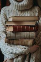 hands holding stacks of books photo