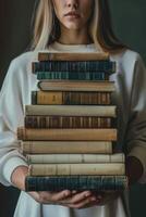 hands holding stacks of books photo