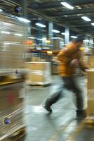 Blurred image of employees in a warehouse photo