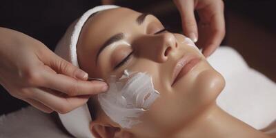 woman in spa salon working with facial skin photo