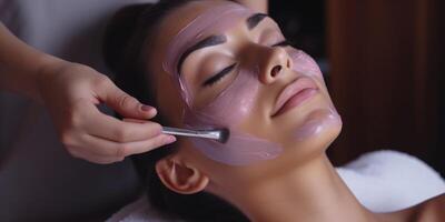 woman in spa salon working with facial skin photo