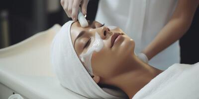 woman in spa salon working with facial skin photo