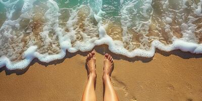 female feet in the sand on the beach photo