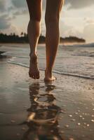 female feet in the sand on the beach photo