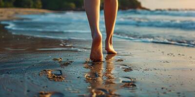 female feet in the sand on the beach photo