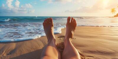 female feet in the sand on the beach photo