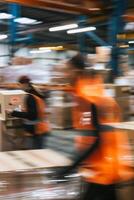 Blurred image of warehouse employees photo