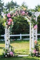 Floral wedding arch in nature photo