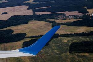 aerial view of landscape with view of aircraft wing photo