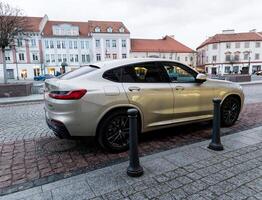 Lithuania, Vilnius, April 11, 2024 - BMW X4 parked in the street photo